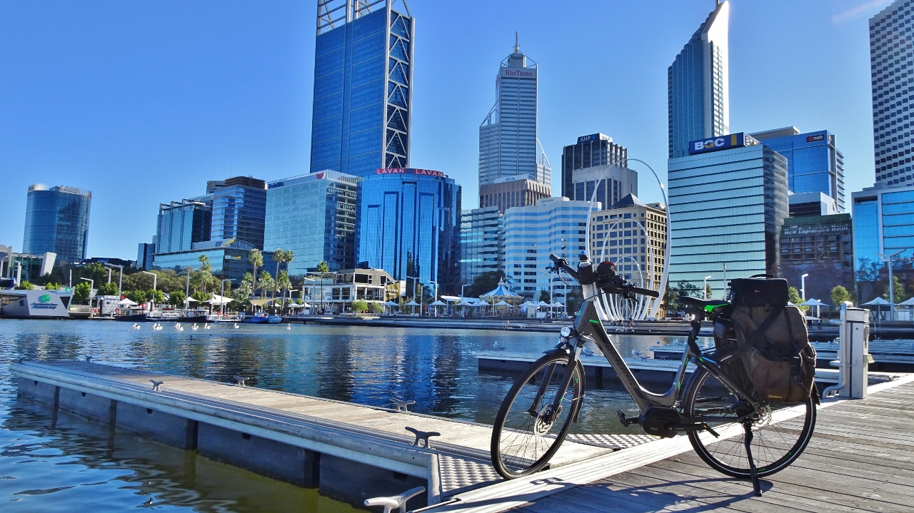 Photo of the city of Perth skyline, the Swan River and an e-bike in the foreground