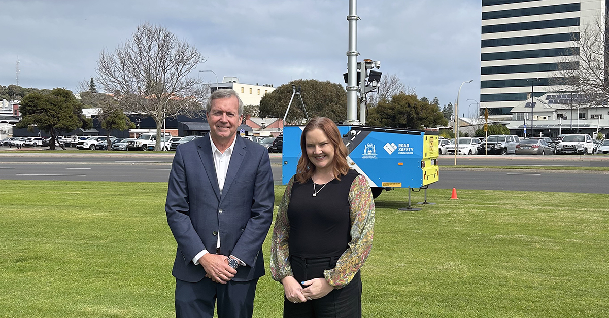 Hon. Reece Whitby Minister for Road Safety and Assisting the Minister for Transport Jessica Stojkovski stand in front of a saefty camera trailer in Perth