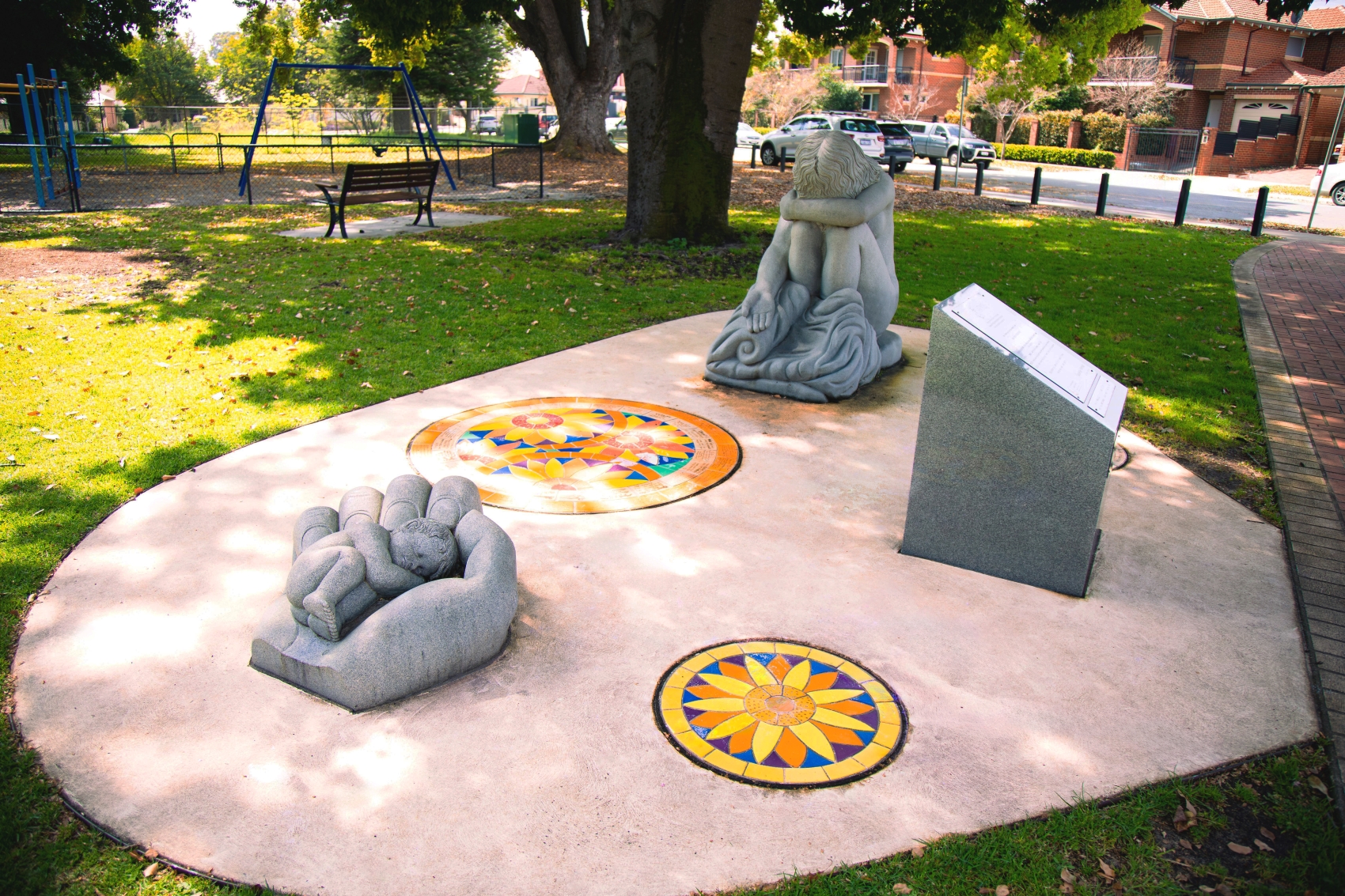 Photo of a memorial sculpture called Empty Arms – Broken Lives, representing mothers separated from their children by adoption. It includes a sculpture of a baby and a crying mother
