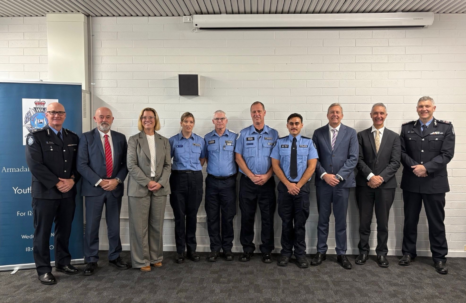 A group photo of 8 people - the award winners, police and ministers