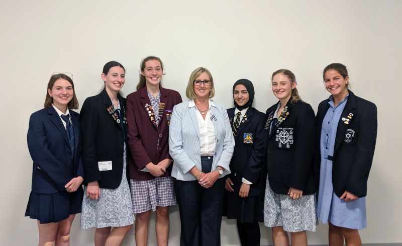 Commissioner Sharyn O’Neill with (left to right) Sophia Rees (Shenton College), Natasha Farrington (Perth College), Wini Taylor-Williams (St Mary’s Anglican Girls School) for the affirmative; and Huda Zaidi (Perth Modern School), Keeley Sermon (Perth College) and Aviya Solomon (Carmel College) for the negative team.
