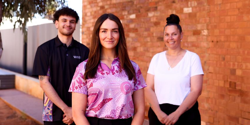 Three Youth Justice Officers standing in from of an office building and posing for the camera