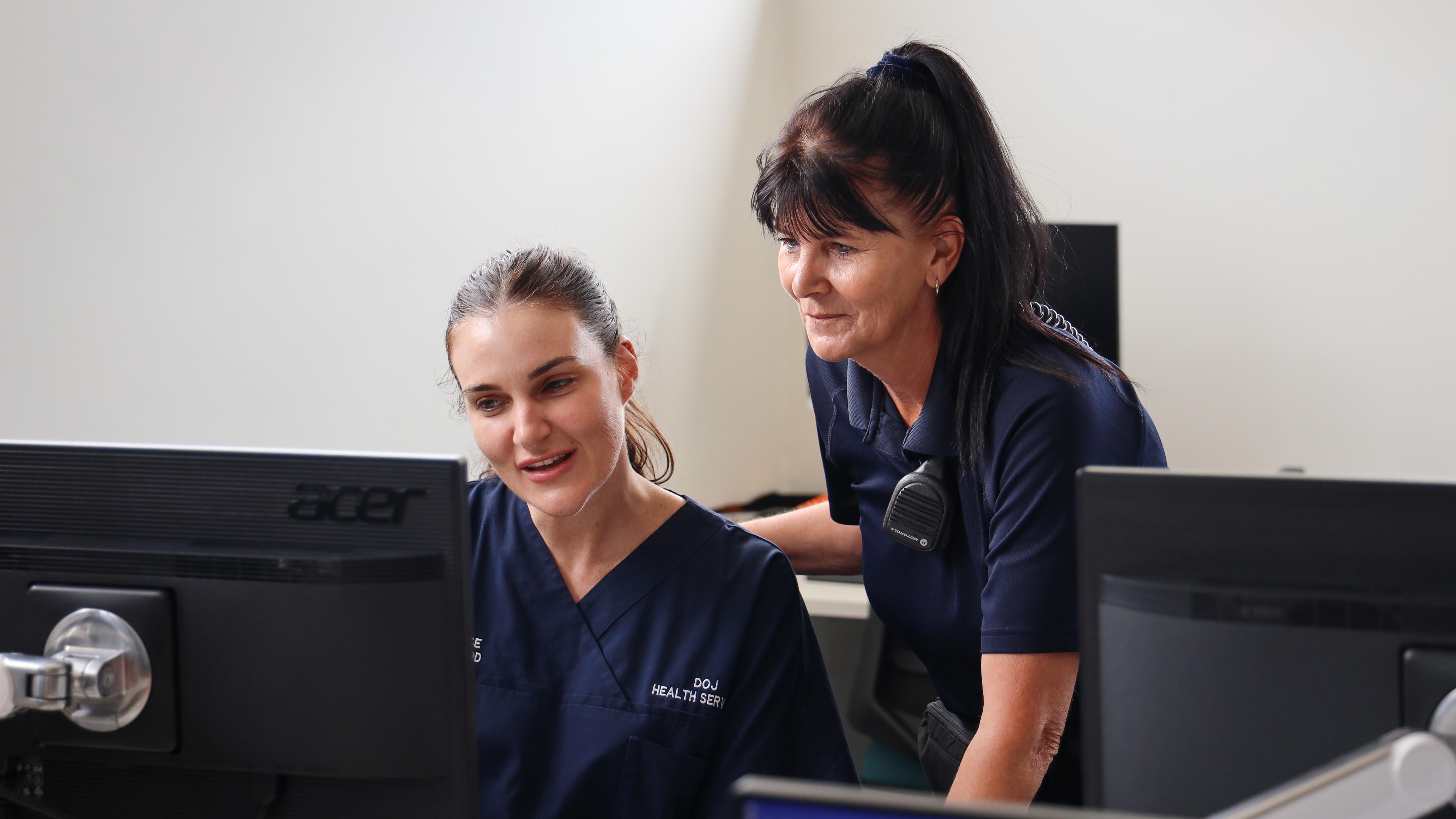 Metal health nurses in front of computer