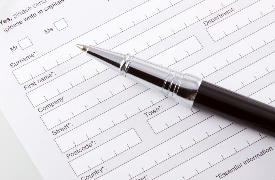 Pen resting on identification form.