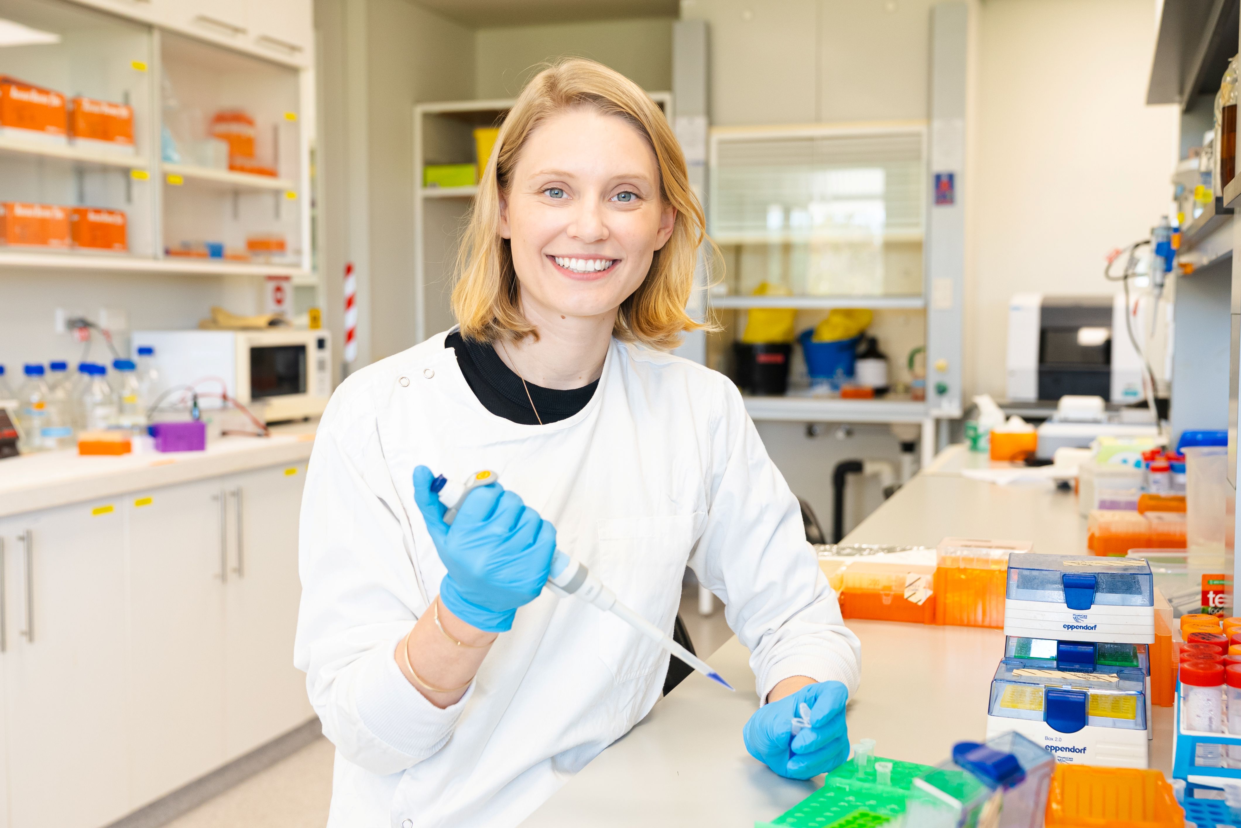 psa finalist jessica kretzmann with sample tube on one hand and pipet on the other