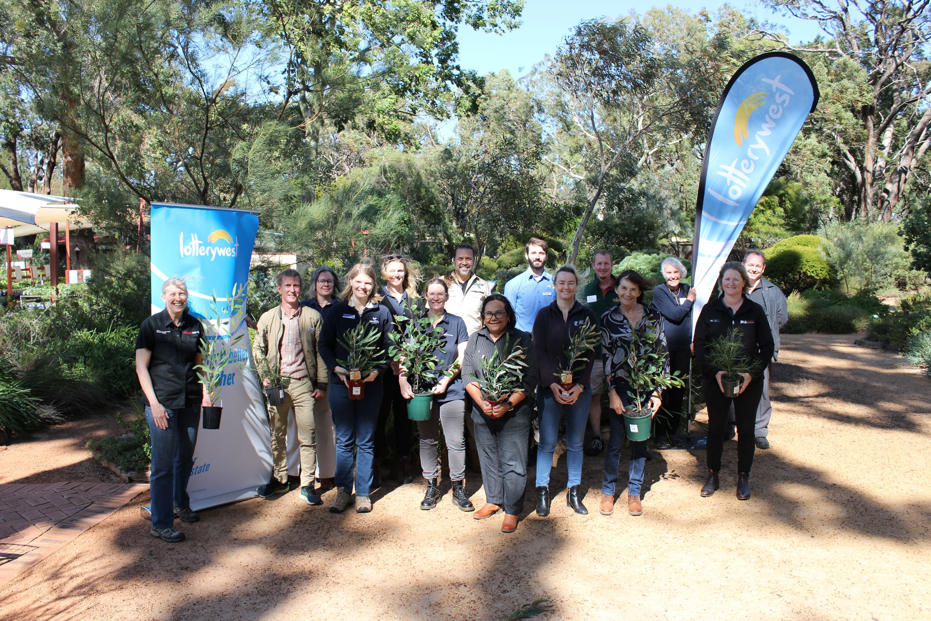 psa finalist keep carnaby flying ngoolarks forever team standing together holding plants 