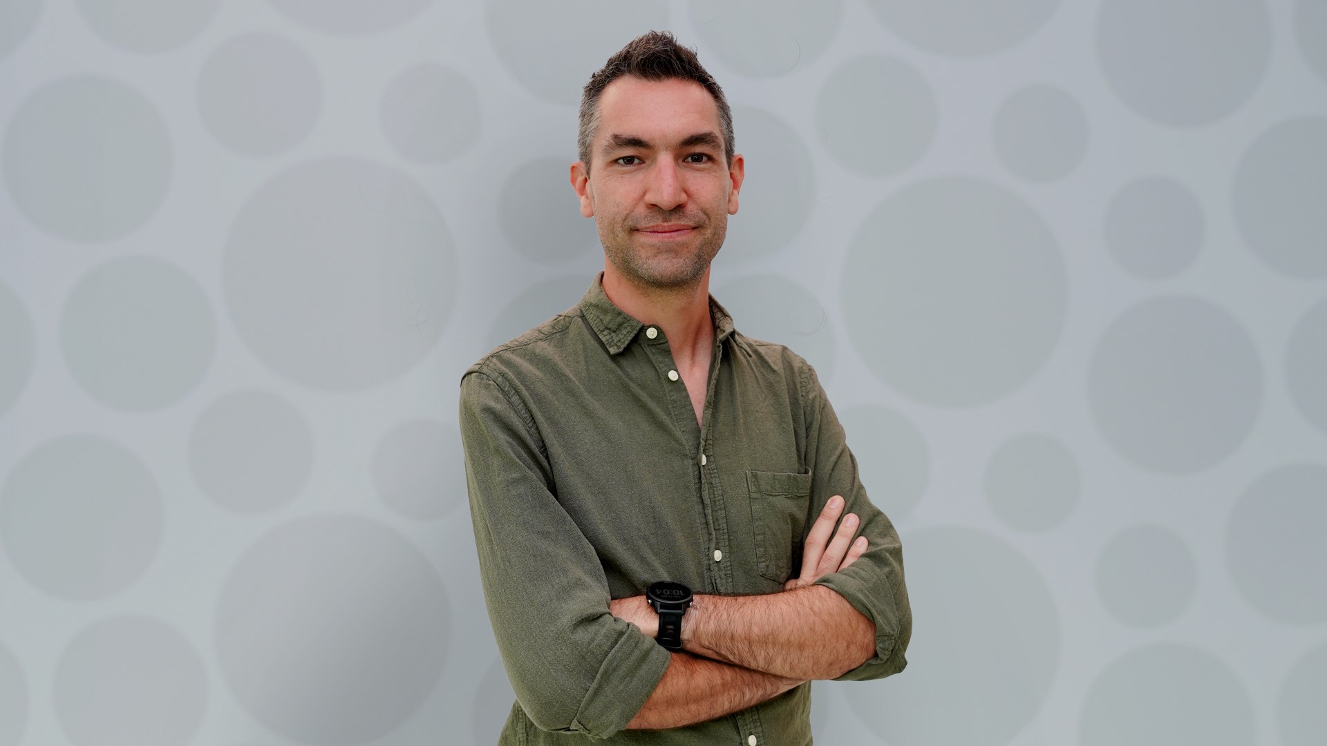 psa finalist nick golding standing in front of grey background crossing arms