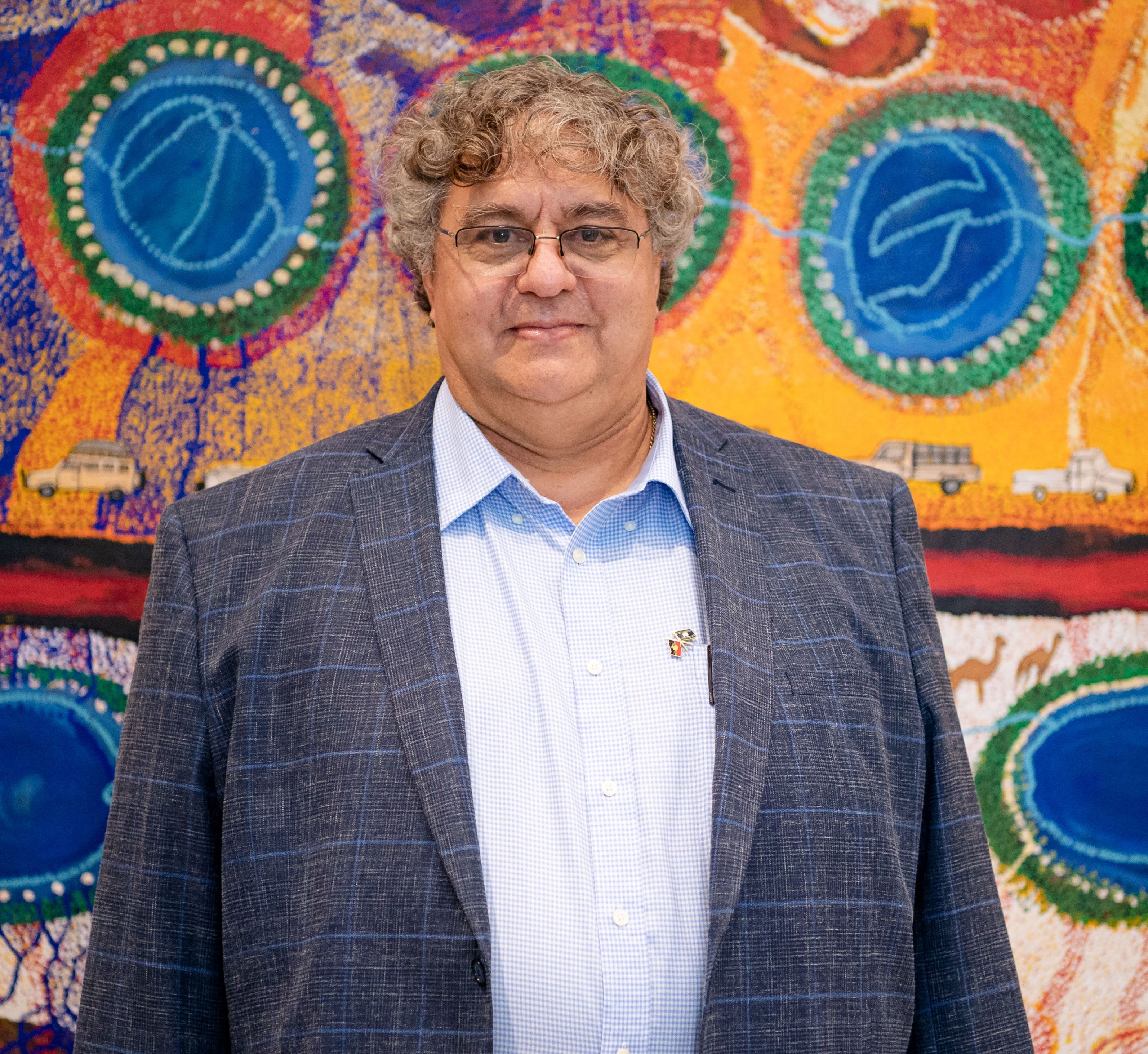 psa finalist stephen van leeuwen standing in front of Aboriginal art