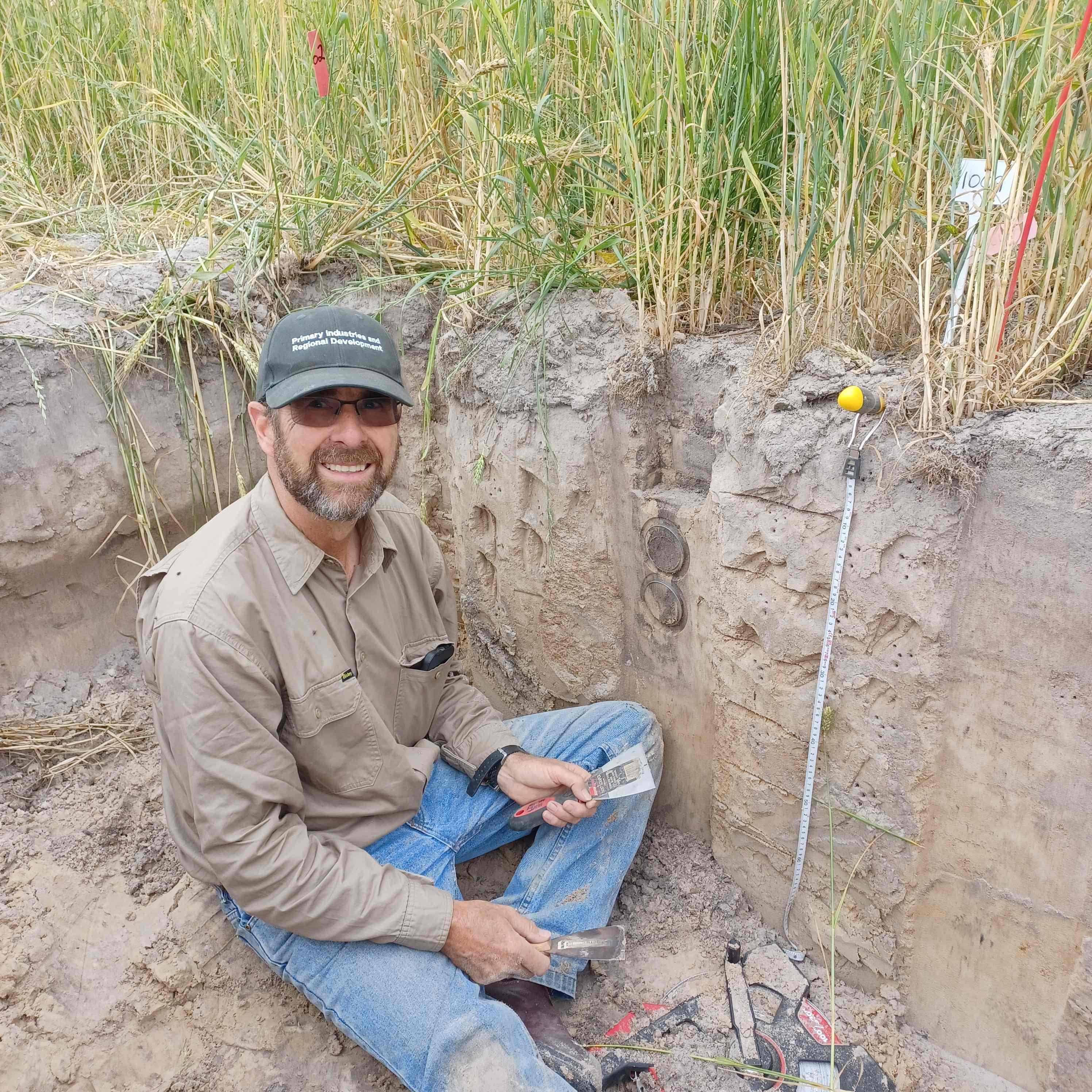 A man sitting in a hole in the ground.