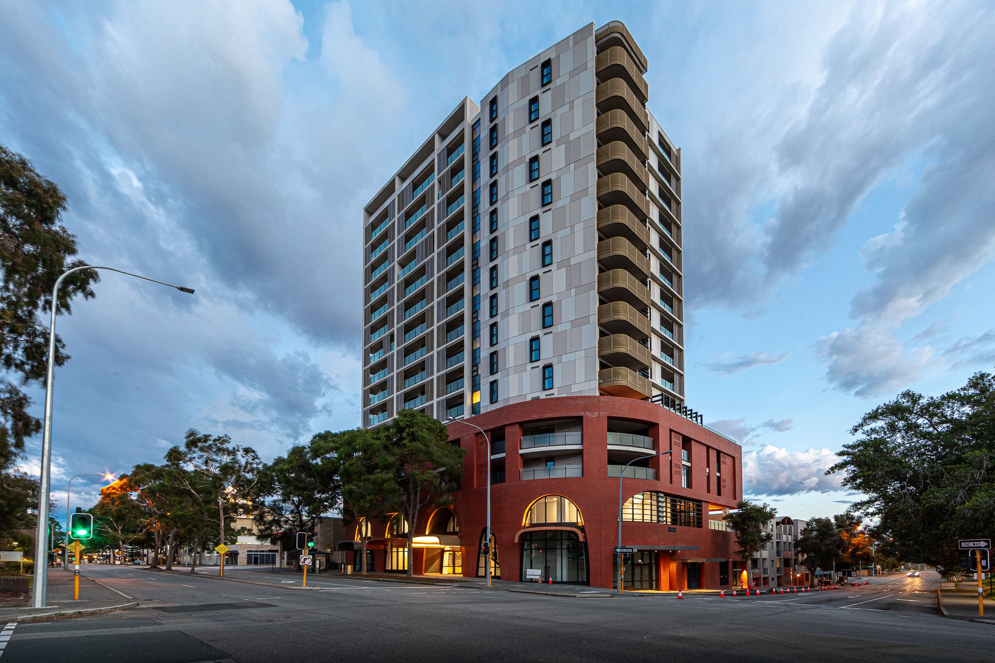 A tall housing complex and the urban city street below the building