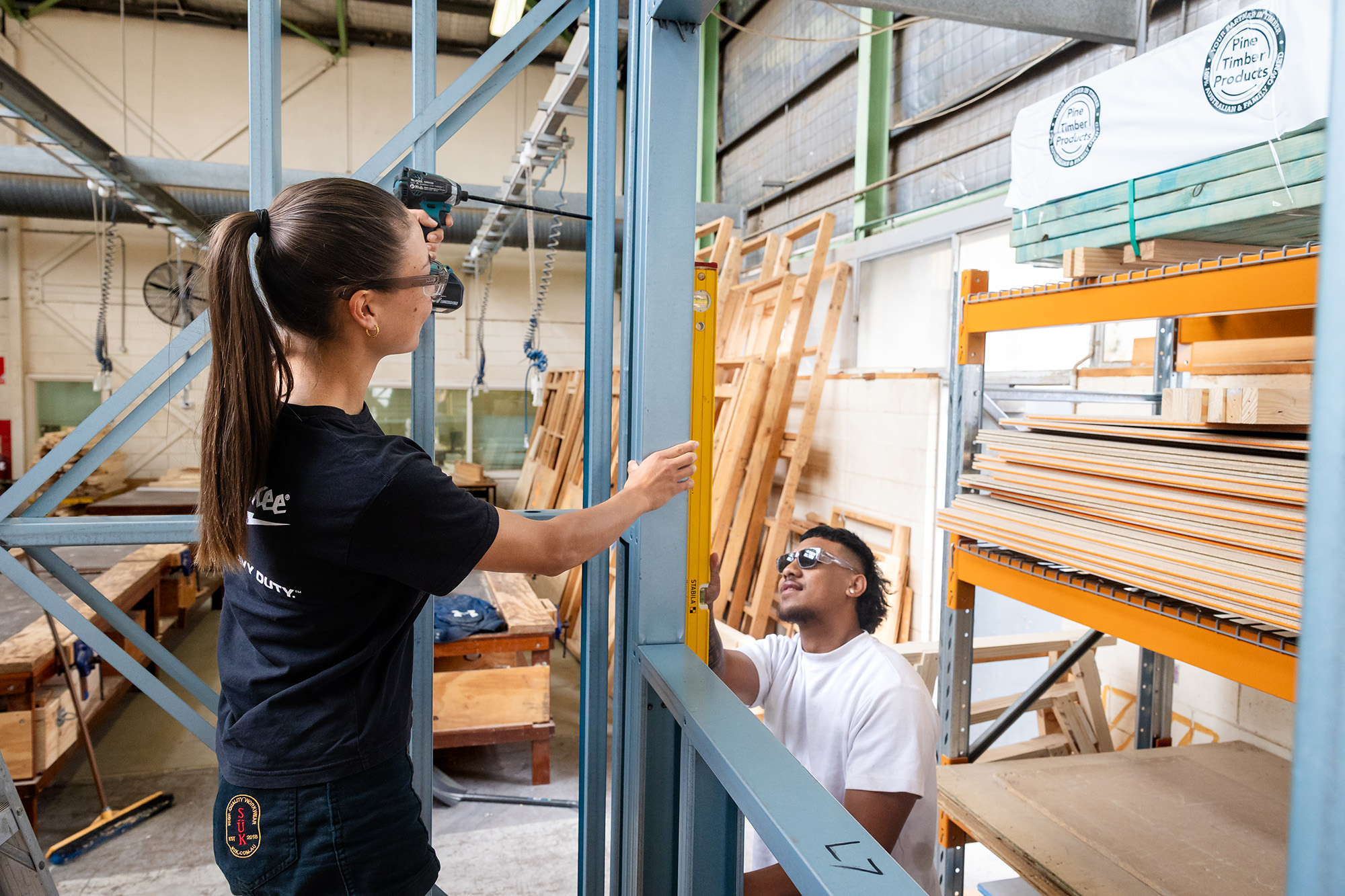 female and male construction students building
