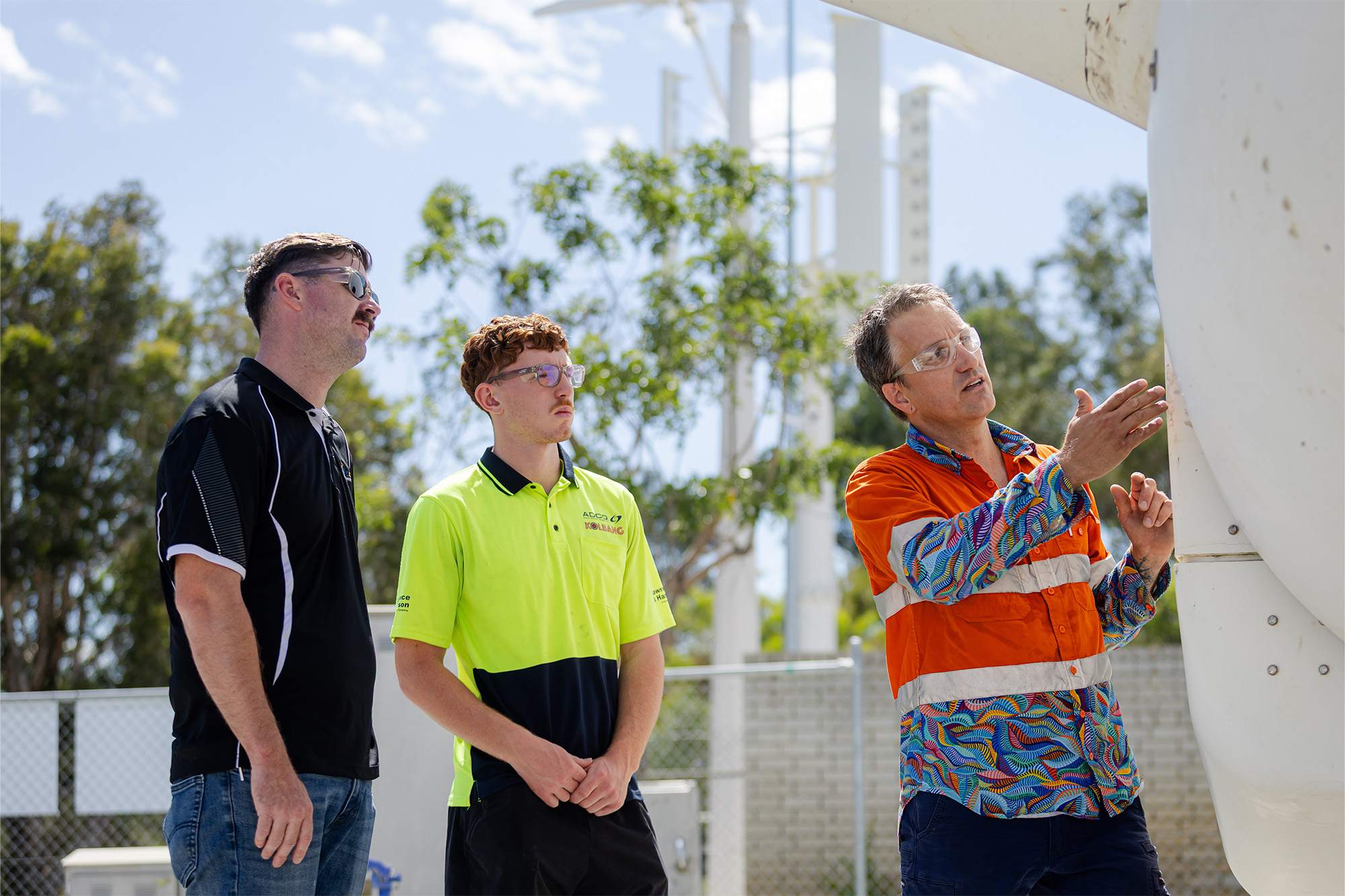 two students watching the lecturer showing them the new clean energy equipment