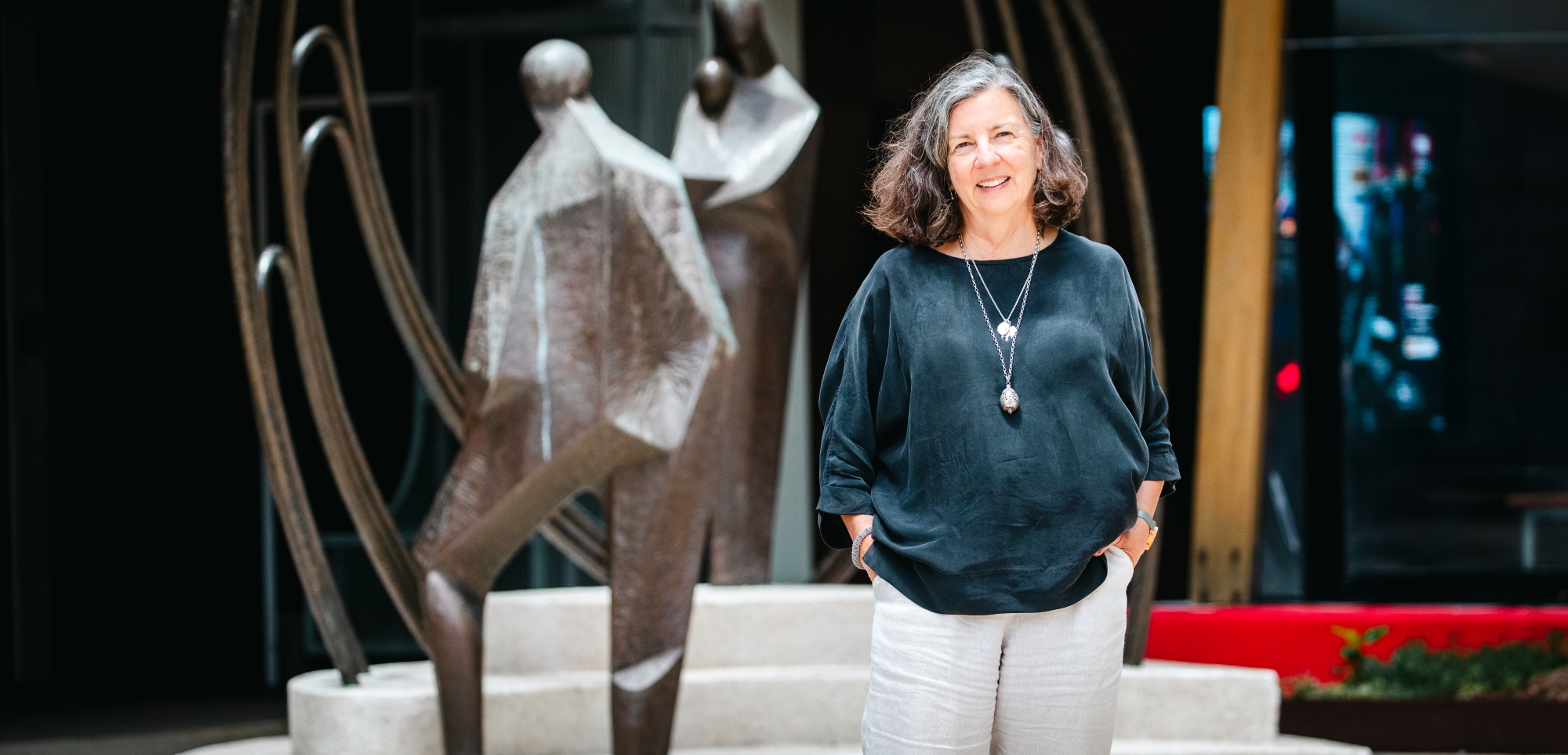 A middle age well dressed women, Caron Irwin, pictured out front of Communities head office building