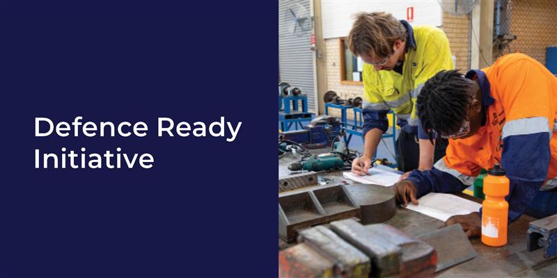 banner with text over blue background that reads 'defence ready initiative' next to it is 2 men in high vis shirts working