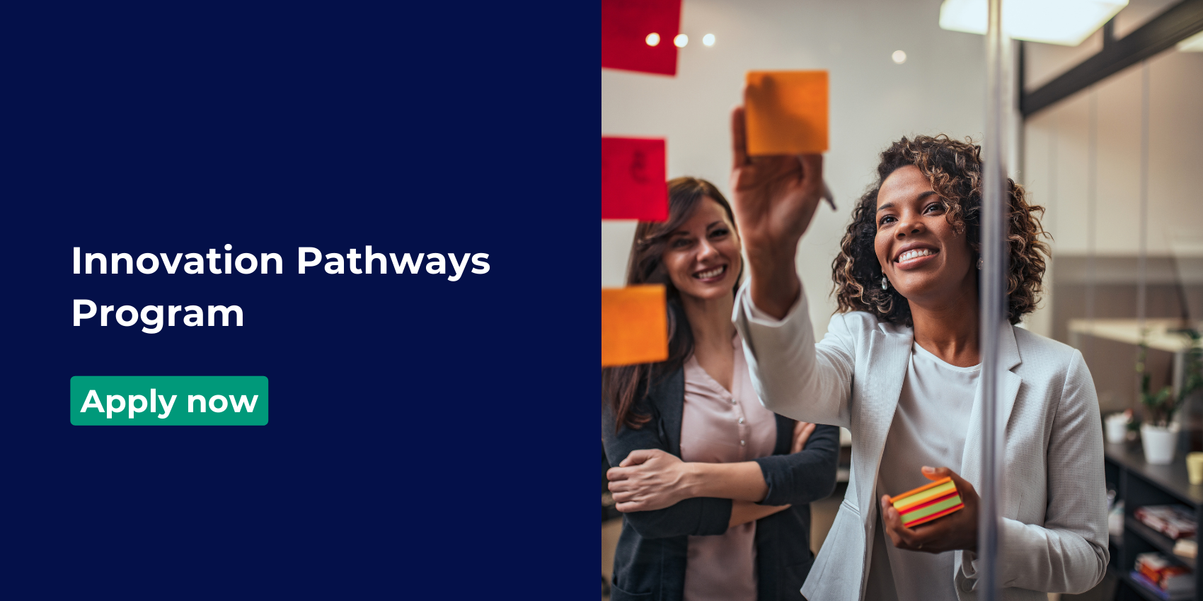 Woman placing post-it-notes on a clear glass window