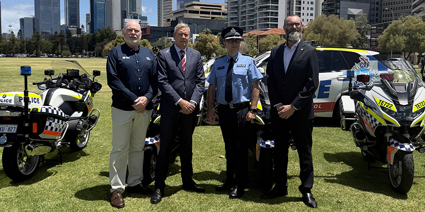 Minister of Road Safety, Road Safety Commissioner and members of the police stand in front of police vehicles in Perth CBD