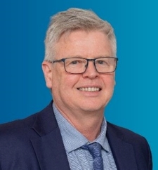 a smiling middle aged man, head and shoulders shot