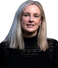 A woman with long hair, smiling head and shoulders shot