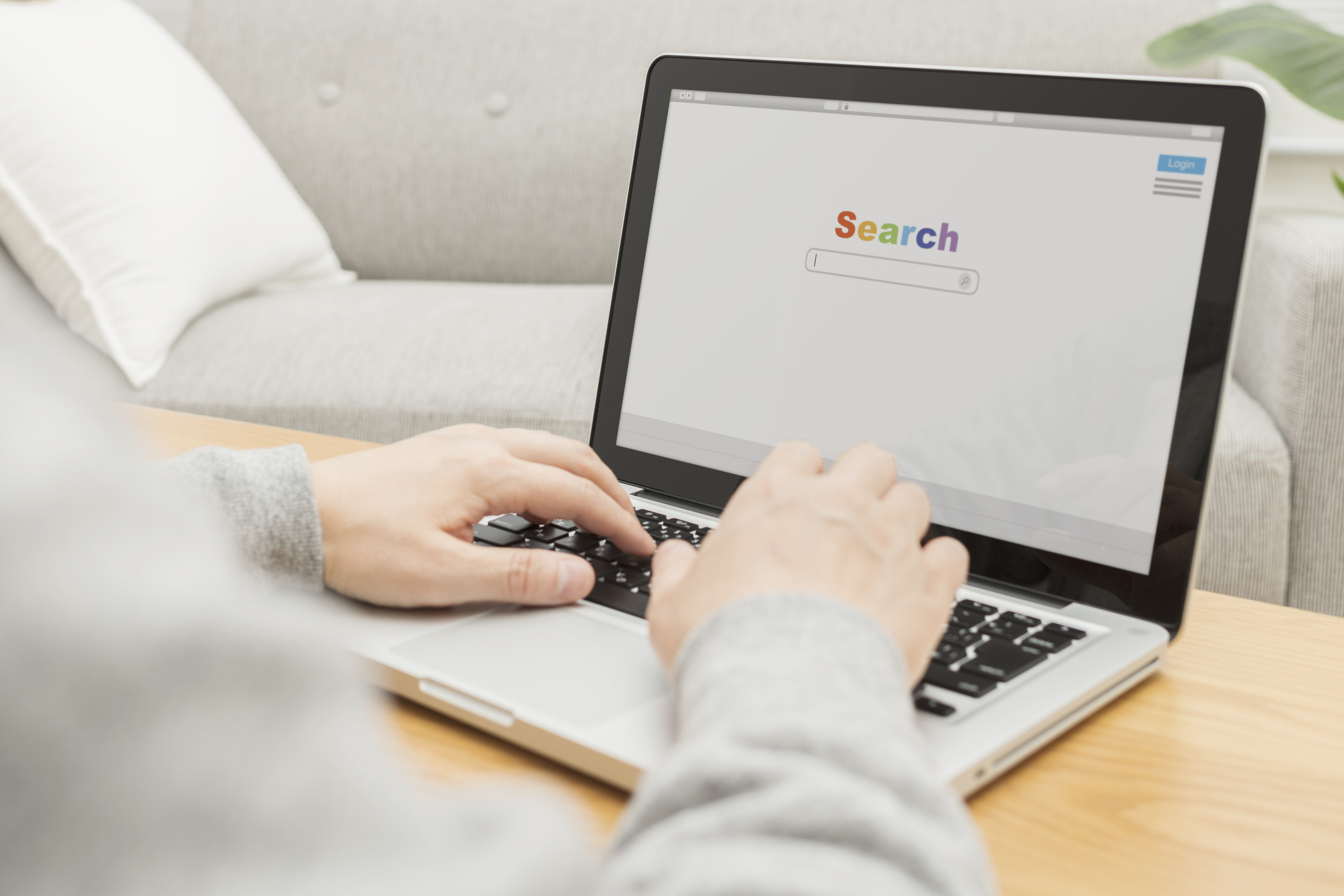 a laptop placed on a desk with someone doing a google search