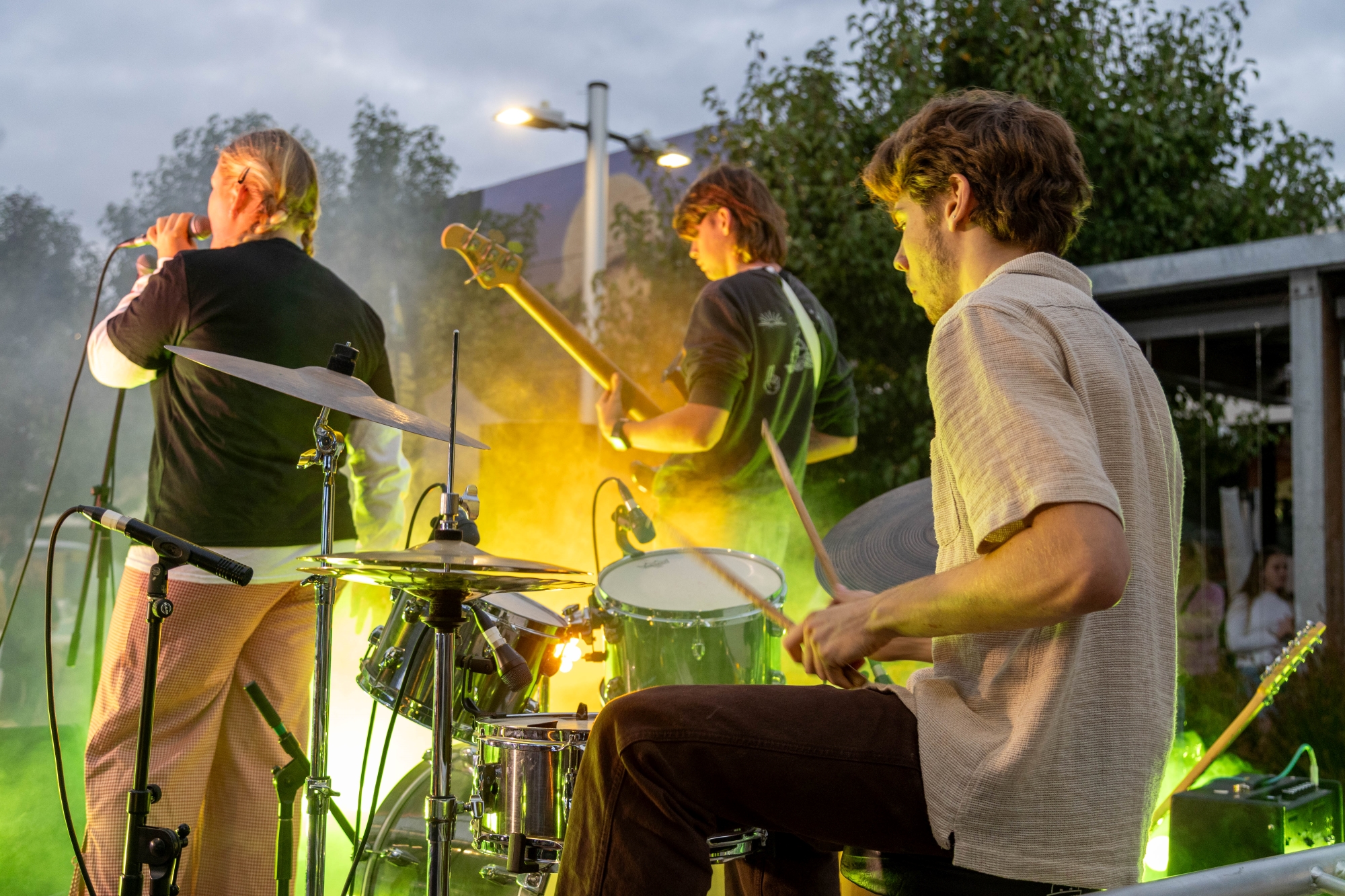 a group of three young musicians on stage playing music