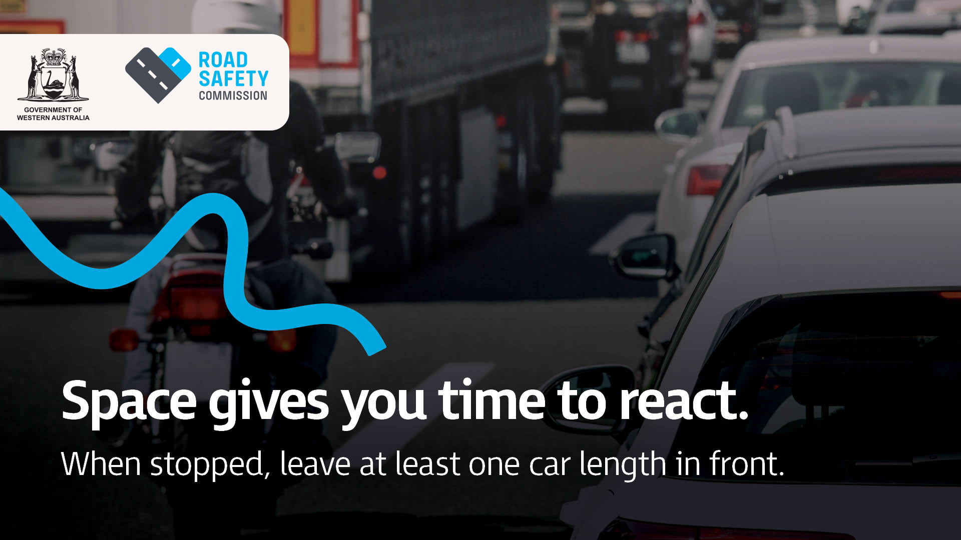 A motorcyclist wearing safety gear safely navigates heavy traffic