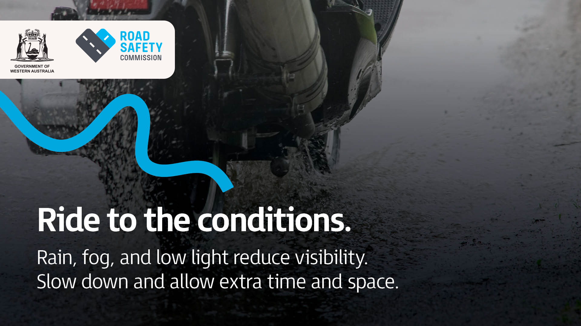 A close up of a backend of a motorcycle driving in rainy wet weather