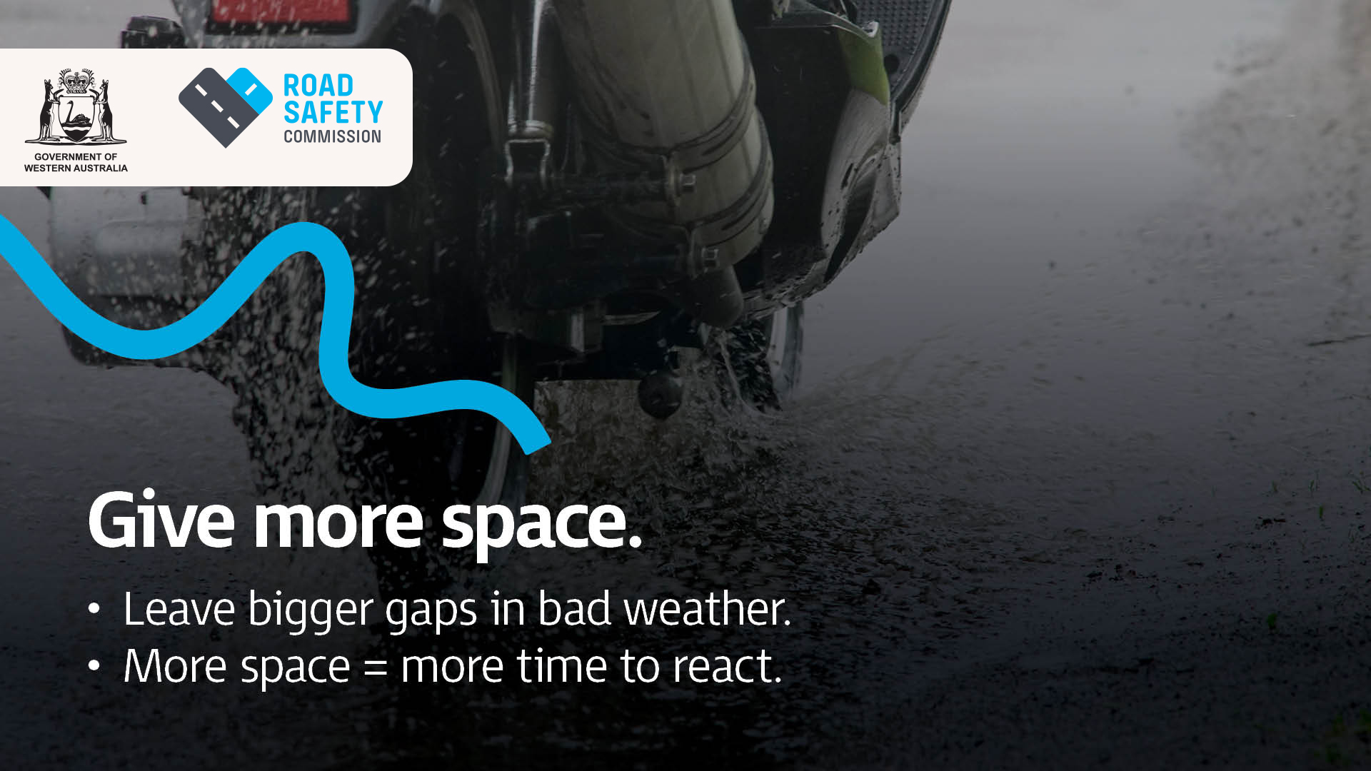 A close up of a motorcyclist riding in wet weather conditions