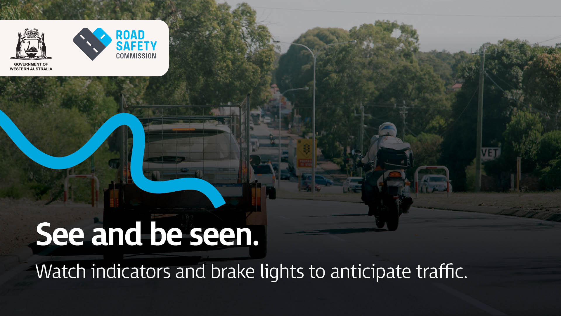 A motorcyclist wearing safety gear riding safely amongst traffic