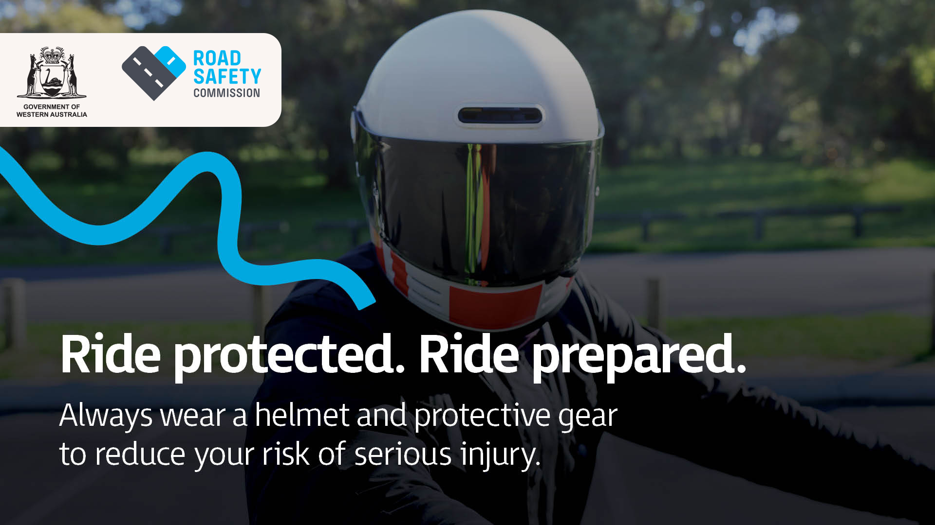 A closeup of motorcyclist wearing a white and orange coloured helmet