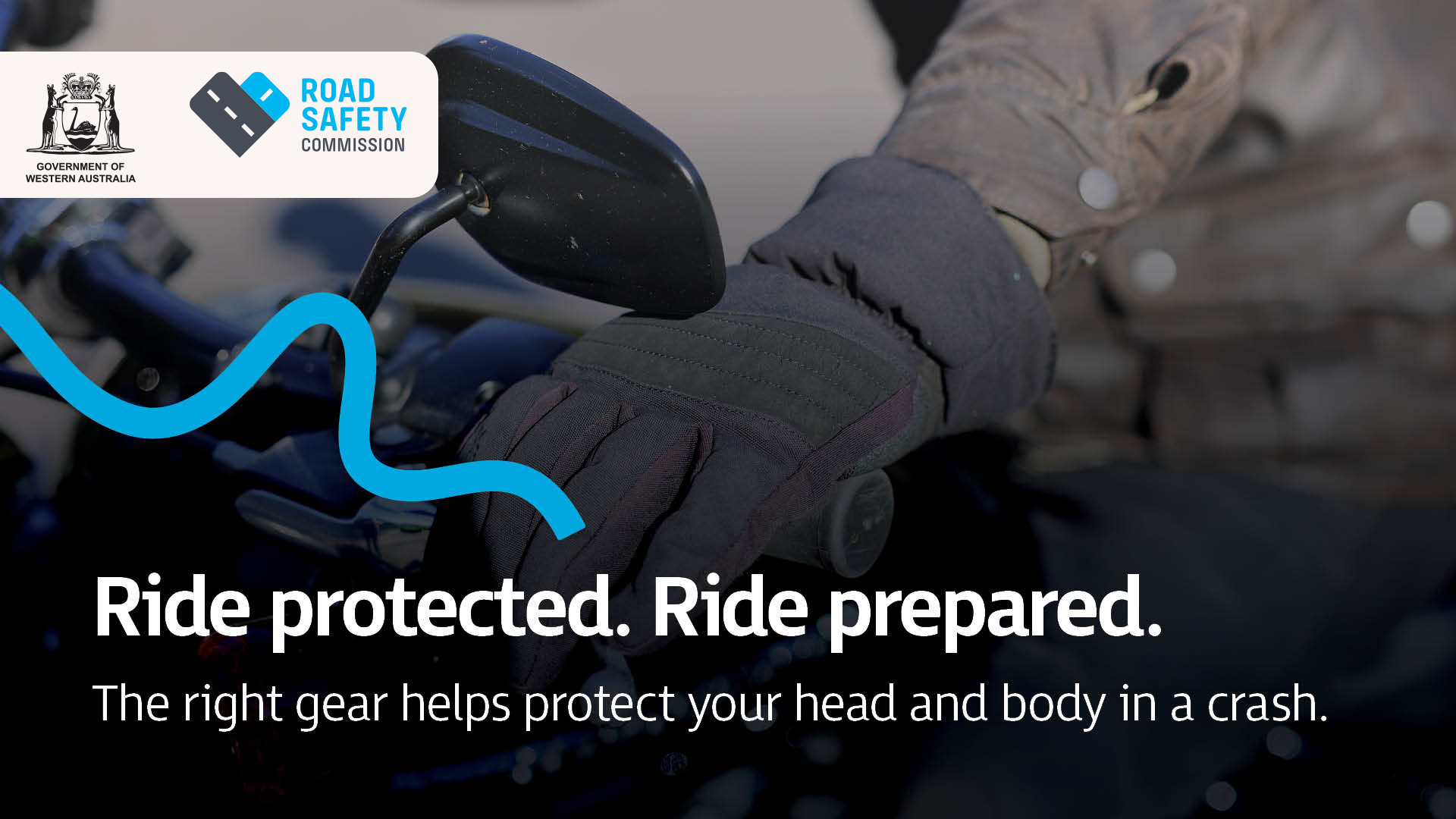 A close up of a motorcyclist's protected hand holding the bars of a motorcycle