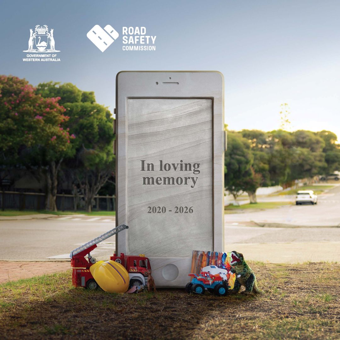 Headstone phone on side of road with text, 'In loving memory' showing a son's belongings