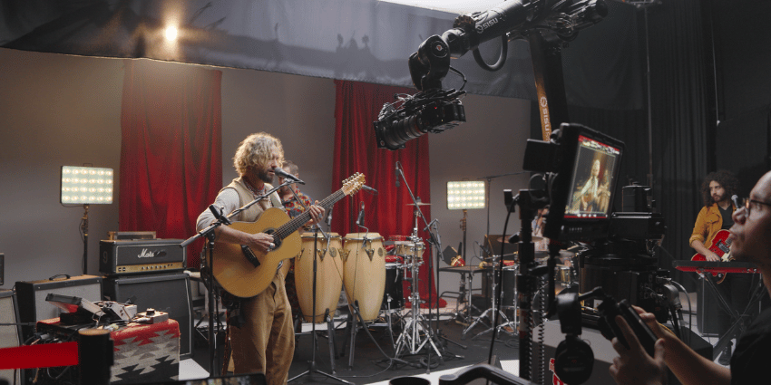 Photo of a band at Raz Studios being filmed for a music video with a robotic camera