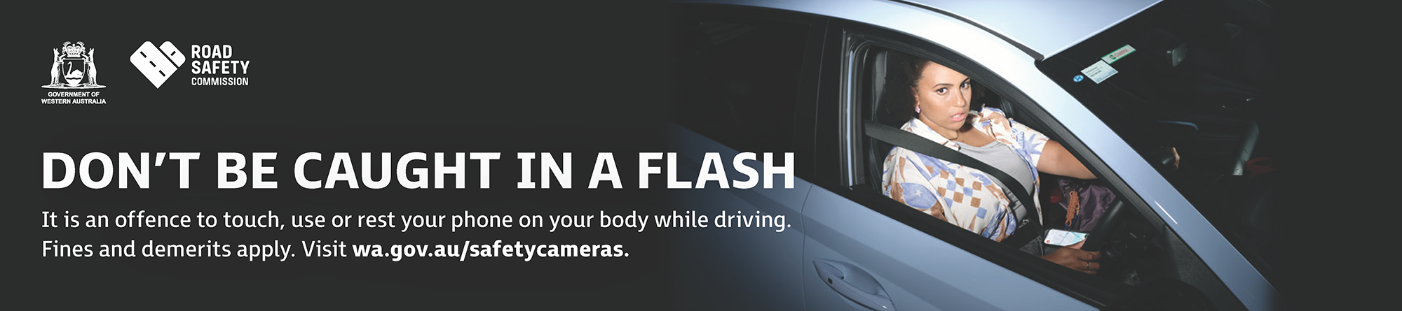 A woman with her phone in lap is 'caught in a flash' as an example of safety camera detection