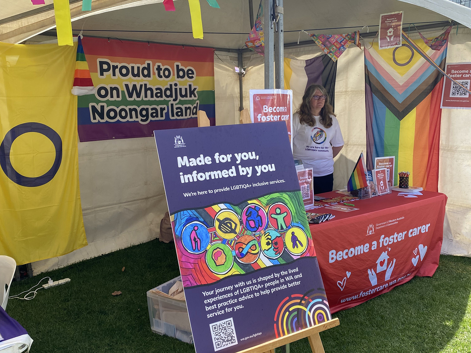 The Department of Communities LGBTIQA+ stall with colourful banners and information