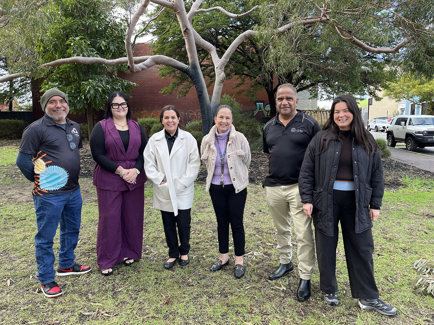 Six adult people in an outdoor setting