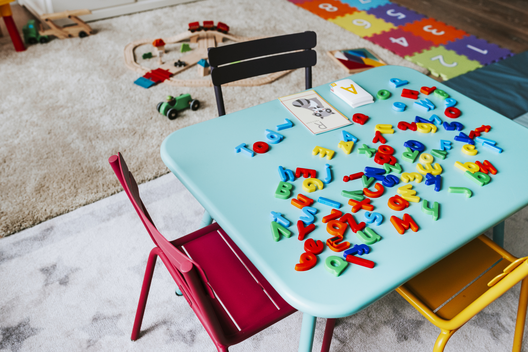 an indoor children's play area with toys and chairs but no people