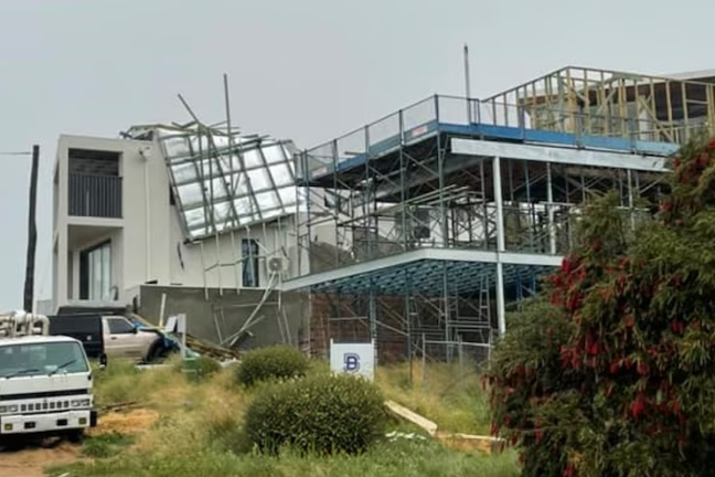 Roof panels and beams blown on to a neighbouring house