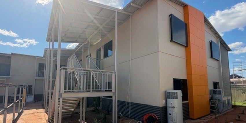 A two-storey apartment building with stairs.