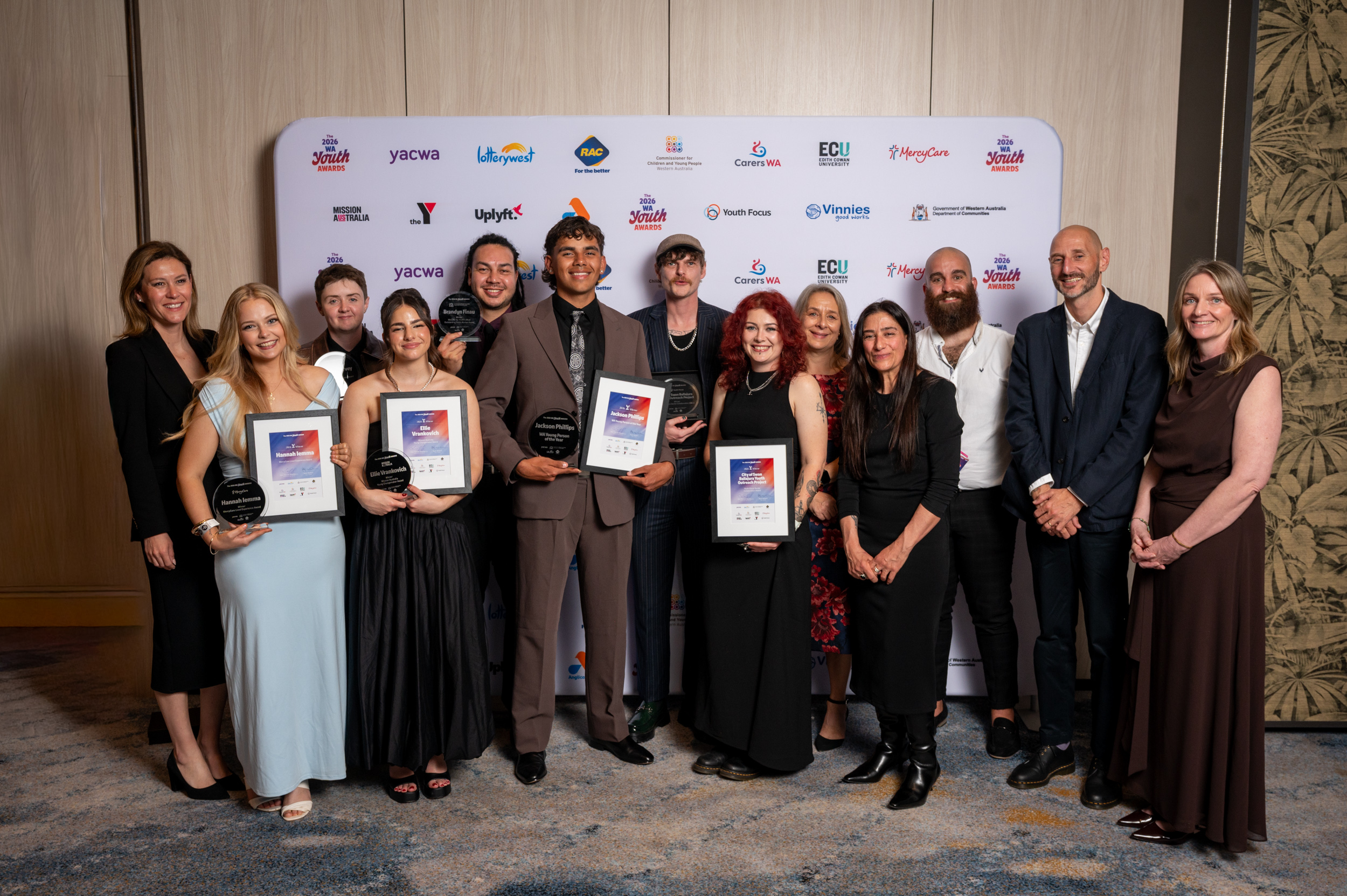 a group of adult people on stage, well dressed, smiling and celebratory at the 2026 WA Youth Awards Ceremony