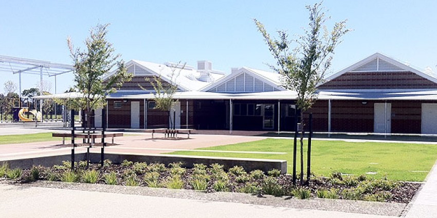 Artist impression of school building with lawn, trees and plants.