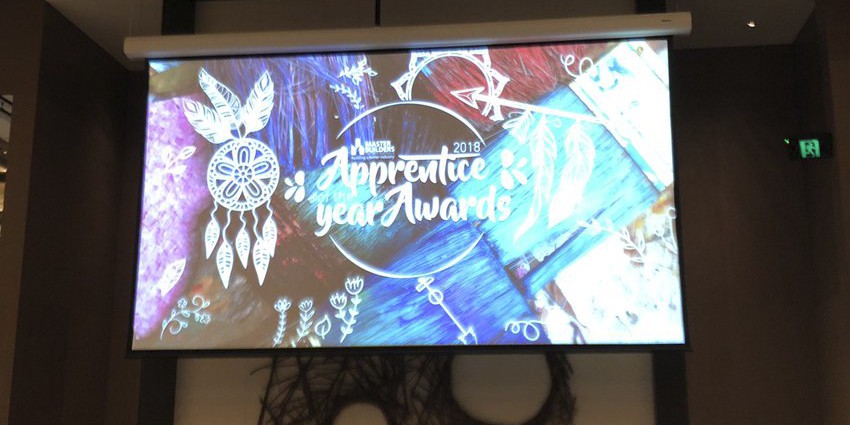 Projector screen displaying 'Apprentice of the Year Awards' text.