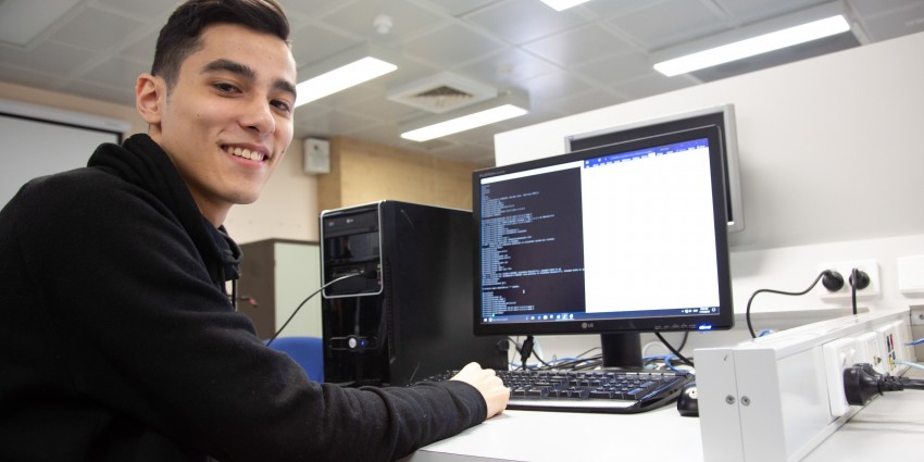 Photo of student sitting in front of computer 
