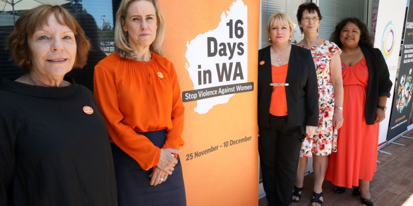 Minister McGurk at the launch of two new family and domestic violence hubs. The minister is standing in front of an orange 16 Days in WA banner.