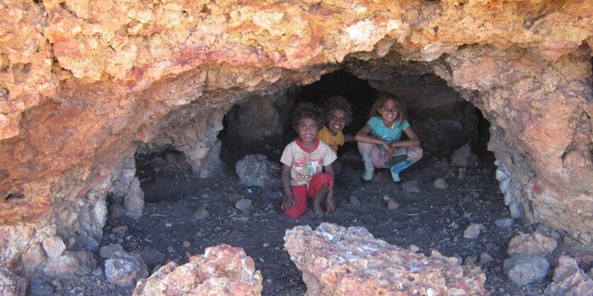 Aboriginal children in rock cave