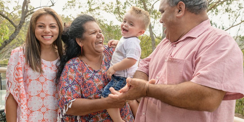Four members of a happy family spanning three generations.