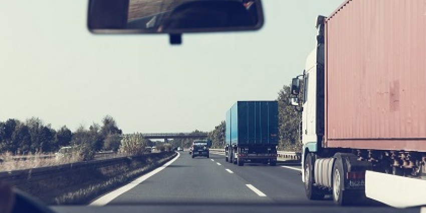 POV of a driver overtaking trucks on a highway