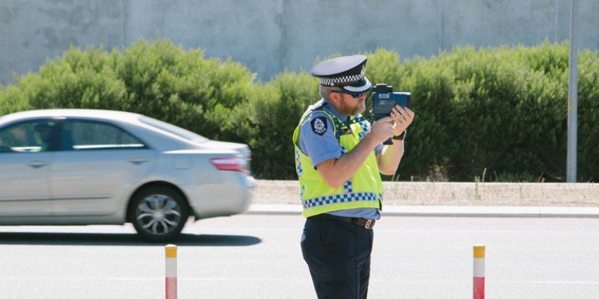 Policeman with speed detection gun