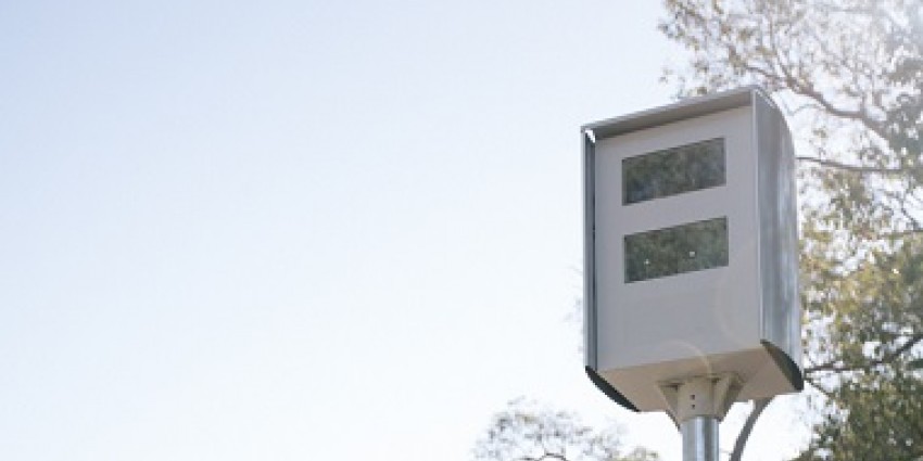 Speed camera in front of trees