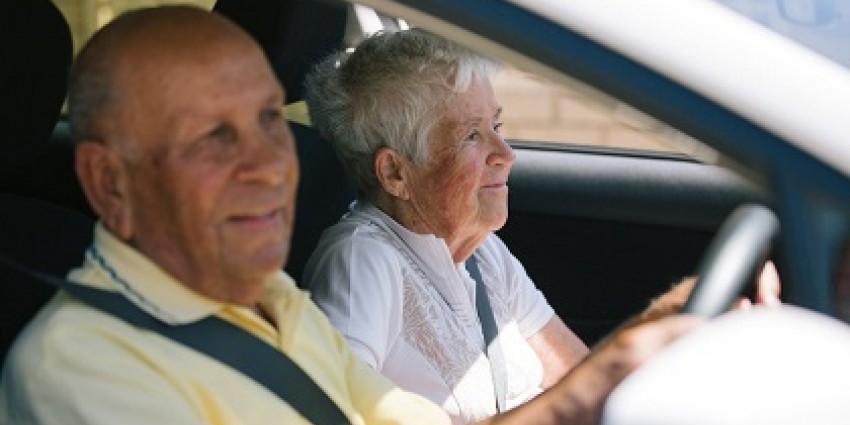 A senior couple driving.