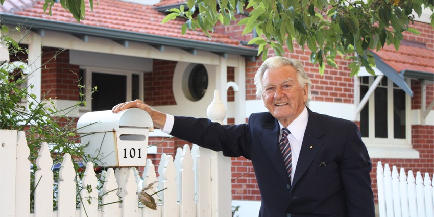 Former prime minister Bob Hawke standing in front of his childhood home